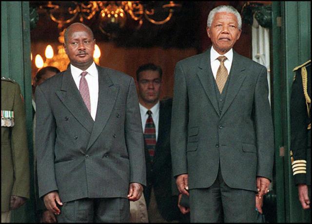 (FILES) Ugandan president, Yoweri Museveni (L) and South African President Nelson Mandela stand to attention for a twenty-one gun salute in Cape Town on May 27, 1997. Yoweri Museveni has been president longer than most Ugandans have been alive, and shows no sign of giving up his place among the world's longest-serving leaders.
Museveni says he is fighting fit and ready for a seventh term if he wins January 15, 2026's election. (Photo by Anna ZIEMINSKI / AFP)