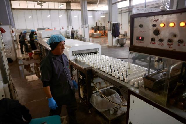 A Palestinian employee inspects sweet locally known as "al-Shatwi" (Winter) Crimbo sweets, as the Al-Arees factory gradually resumes operations after a hiatus caused by the Gaza war which led to shortages of raw materials used in their products, in Deir al-Balah, in the central Gaza Strip on January 12, 2026, following a US-brokered truce that halted the two-year war. (Photo by Bashar Taleb / AFP)