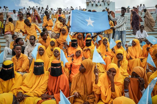 (FILES) Residents wave Somali flags as they attend a rally denouncing Israel’s recent announcement recognizing the breakaway Somaliland region, during a gathering calling for Somalia’s territorial unity at Mogadishu Stadium in Mogadishu on December 30, 2025. Somalia cancelled all agreements with the United Arab Emirates on January 12, 2026 amid tensions over Israel's recognition of Somaliland and reports the Emiratis used Somali territory to help a Yemeni separatist flee his country. (Photo by Hassan Ali ELMI / AFP)