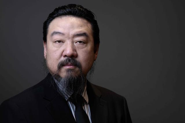 Chinese artist Son Dong, a major figure in contemporary Chinese art, poses during a photo session at Le Bon Marche department store in Paris on January 12, 2026. (Photo by Joel Saget / AFP)