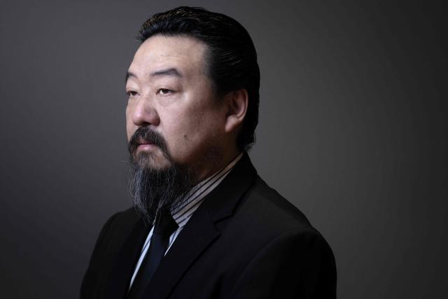 Chinese artist Son Dong, a major figure in contemporary Chinese art, poses during a photo session at Le Bon Marche department store in Paris on January 12, 2026. (Photo by Joel Saget / AFP)