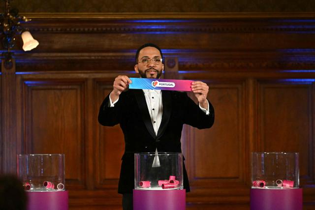 Moderator Austrian singer Cesar Sampson holds a draw for Portugal during the draw session for the two semi-final events of the Eurovision Song Contest 2026 on stage at the Vienna’s city hall in Vienna, Austria, on January 12, 2026. Vienna hosts the Eurovision Song Contest 2026 on May 12-14. (Photo by Joe Klamar / AFP)
