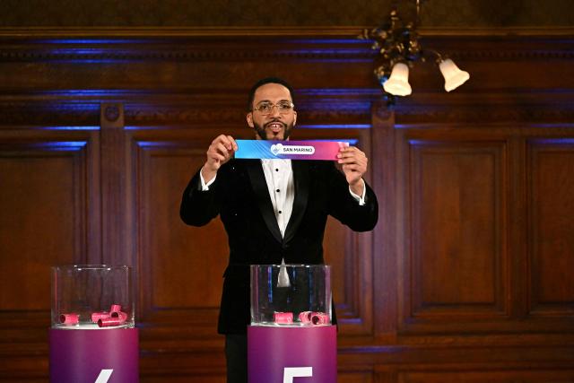 Moderator Austrian singer Cesar Sampson holds a draw for San Marino during the draw session for the two semi-final events of the Eurovision Song Contest 2026 on stage at the Vienna’s city hall in Vienna, Austria, on January 12, 2026. Vienna hosts the Eurovision Song Contest 2026 on May 12-14. (Photo by Joe Klamar / AFP)