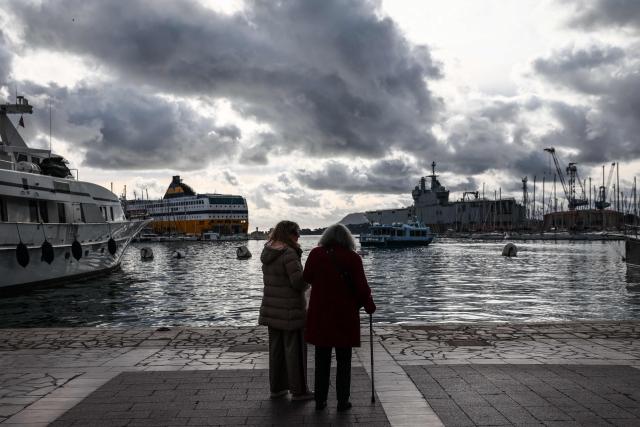 Local residents stand in front of the port of Toulon, southern France, on January 12, 2026, (Photo by Thibaud MORITZ / AFP)