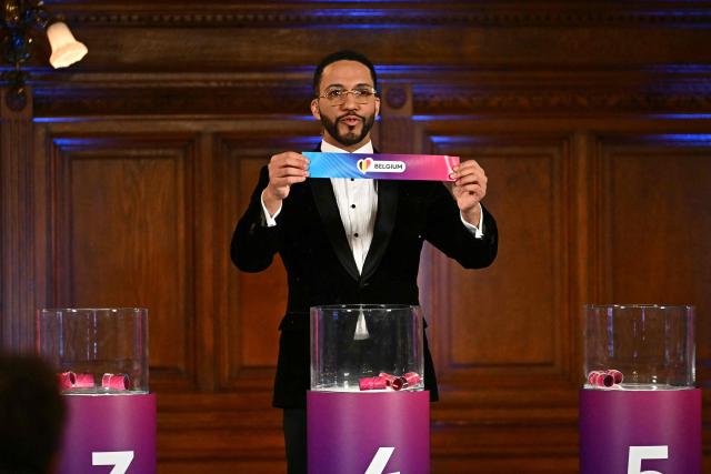 Moderator Austrian singer Cesar Sampson holds a draw for Belgium during the draw session for the two semi-final events of the Eurovision Song Contest 2026 on stage at the Vienna’s city hall in Vienna, Austria, on January 12, 2026. Vienna hosts the Eurovision Song Contest 2026 on May 12-14. (Photo by Joe Klamar / AFP)