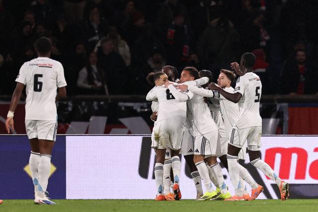 Paris FC's French players celebrate Paris FC's French midfielder #14 Jonathan Ikone goal during the French Cup round of 32 football match between between Paris Saint-Germain (PSG) and Paris FC at the Parc des Princes stadium in Paris on January 12, 2026. (Photo by Anne-Christine POUJOULAT / AFP)