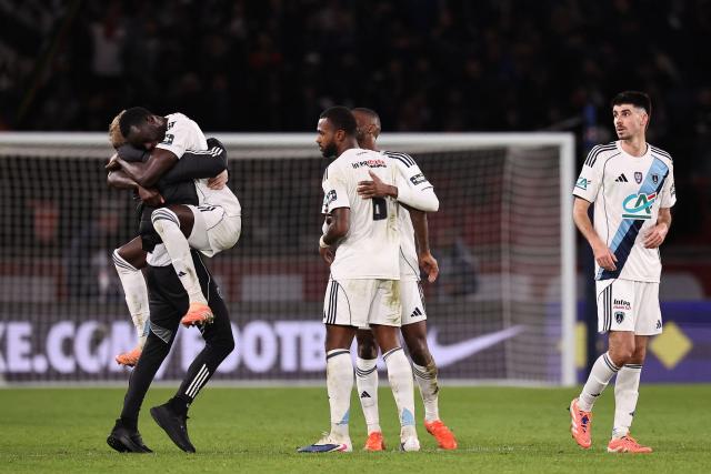 Paris FC's players celebrate after winning their French Cup round of 32 football match against Paris Saint-Germain (PSG) at the Parc des Princes stadium in Paris on January 12, 2026. (Photo by Anne-Christine POUJOULAT / AFP)