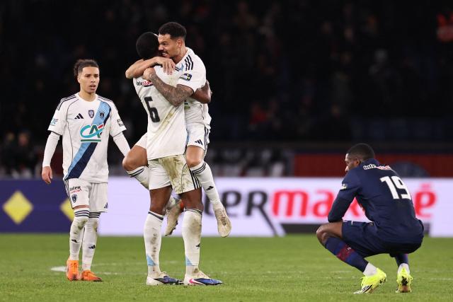 (From L) Paris FC's French midfielder #17 Ilan Kebbal, Paris FC's Brazilian defender #06 Otavio and Paris FC's French defender #04 Timothee Kolodziejczak celebrate next to Paris Saint-Germain's French forward #19 Ousmane Dembele after winning their French Cup round of 32 football match against Paris Saint-Germain (PSG) at the Parc des Princes stadium in Paris on January 12, 2026. (Photo by Anne-Christine POUJOULAT / AFP)