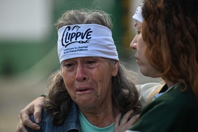 Relatives wait for news on their beloved ones, outside of the Zone 7 of the Bolivarian National Police (PNB) --aka Boleita Detainee Control and Custody Centre-- in Sucre municipality, Metropolitan District of Caracas (DMC) on January 12, 2026. Venezuela said that 116 political prisoners have been released since the government announced last week it would begin freeing those jailed under president Nicolas Maduro, who was seized by US forces in a raid on Caracas. (Photo by Juan BARRETO / AFP)