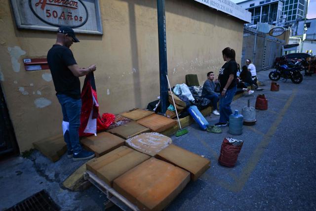 Relatives wait for news on their beloved ones, outside of the Zone 7 of the Bolivarian National Police (PNB) --aka Boleita Detainee Control and Custody Centre-- in Sucre municipality, Metropolitan District of Caracas (DMC) on January 12, 2026. Venezuela said January 12, it had freed dozens more political prisoners as rights groups questioned the numbers and family members clamored for speedier releases after the US military ouster of long-term autocrat Nicolas Maduro. (Photo by Juan BARRETO / AFP)
