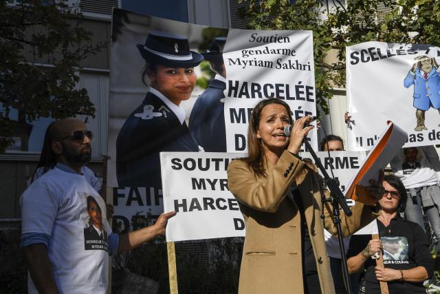 (FILES) Hassina Sakhri (C), sister of the French gendarme Myriam Sakhri found dead on 2011, speaks during a protest with friends and relatives to demand a new investigation in front of the courthouse of Lyon, southeastern France, on October 24, 2018. The Lyon court will deliberate on January 15, 2026 in the Myriam Sakhri case. The family of a gendarme who died in 2011 in her apartment of Lyon's national gendarmerie compund continues to denounce the investigation that concluded to her suicide and demand the opening of a new investigation. (Photo by PHILIPPE DESMAZES / AFP)