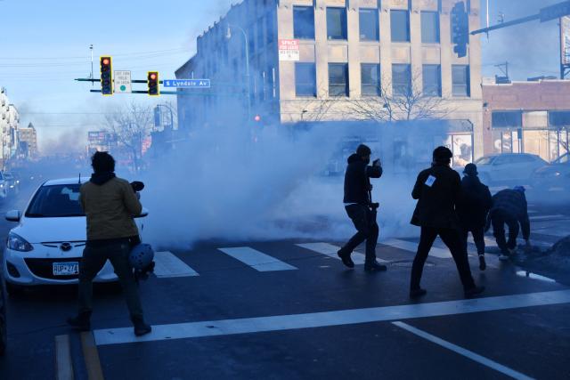 US Customs and Border Protection agents disperse tear gas during a patrol while looking to detain undocumented persons during immigration enforcement activity in Minneapolis, Minnesota, on January 12, 2026. Hundreds more federal agents were heading to Minneapolis, the US homeland security chief said on January 11, brushing aside demands by the Midwestern city's Democratic leaders to leave after an immigration officer fatally shot a woman protester. In multiple TV interviews, US Homeland Secretary Kristi Noem defended the actions of the officer who shot and killed 37-year-old Renee Nicole Good, whose death has sparked renewed protests nationwide against President Donald Trump's immigration crackdown. (Photo by Octavio JONES / AFP)