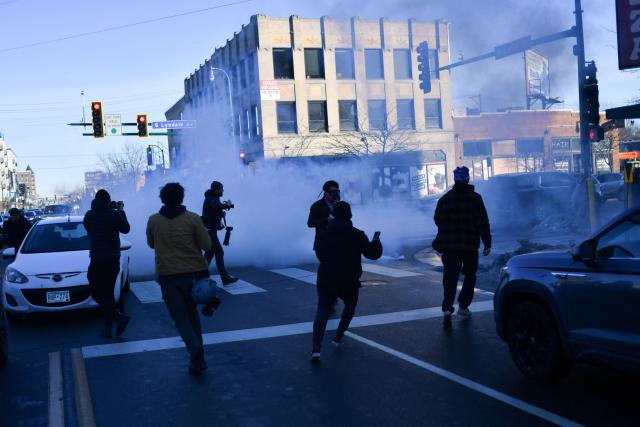 US Customs and Border Protection agents disperse tear gas during a patrol while looking to detain undocumented persons during immigration enforcement activity in Minneapolis, Minnesota, on January 12, 2026. Hundreds more federal agents were heading to Minneapolis, the US homeland security chief said on January 11, brushing aside demands by the Midwestern city's Democratic leaders to leave after an immigration officer fatally shot a woman protester. In multiple TV interviews, US Homeland Secretary Kristi Noem defended the actions of the officer who shot and killed 37-year-old Renee Nicole Good, whose death has sparked renewed protests nationwide against President Donald Trump's immigration crackdown. (Photo by Octavio JONES / AFP)