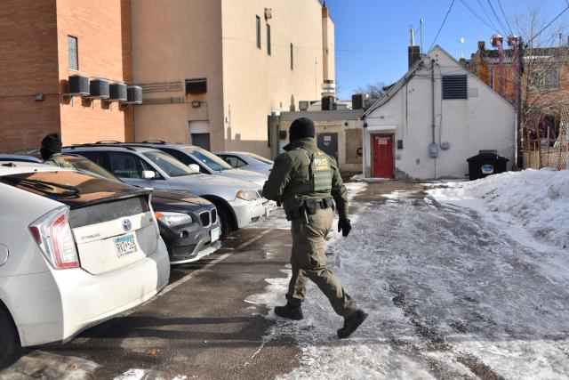 A US Customs and Border Protection agent patrols while looking to detain undocumented persons during immigration enforcement activity in Minneapolis, Minnesota, on January 12, 2026. Hundreds more federal agents were heading to Minneapolis, the US homeland security chief said on January 11, brushing aside demands by the Midwestern city's Democratic leaders to leave after an immigration officer fatally shot a woman protester. In multiple TV interviews, US Homeland Secretary Kristi Noem defended the actions of the officer who shot and killed 37-year-old Renee Nicole Good, whose death has sparked renewed protests nationwide against President Donald Trump's immigration crackdown. (Photo by Octavio JONES / AFP)