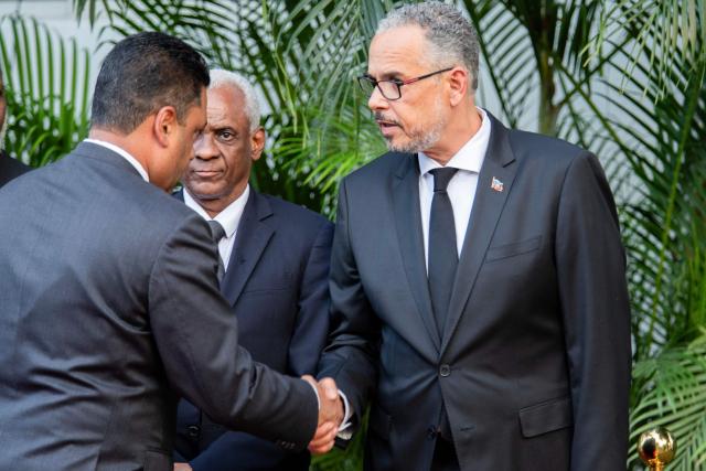 Chairman of the Transitional Presidential Council of Haiti, Laurent Saint-Cyr, greets acting Prime Minister, Prime Minister Alix Didier Fils-Aime, during a tribute to the victims of the January 12, 2010 earthquake in Port-au-Prince, Haiti, on January 12, 2026. (Photo by Clarens SIFFROY / AFP)