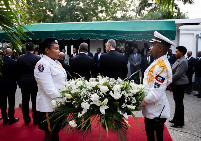 A wreath of flowers is presented in tribute to the victims of the January 12, 2010 earthquake in Port-au-Prince, Haiti, on January 12, 2026. (Photo by Clarens SIFFROY / AFP)