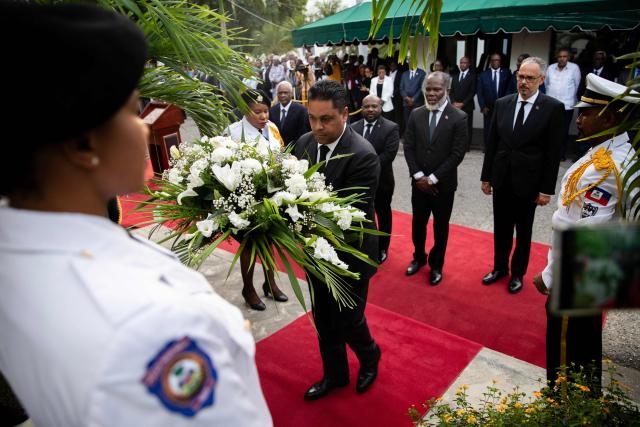 Chairman of the Transitional Presidential Councilof Haiti, Laurent Saint-Cyr, presents a wreath of flowers in tribute to the victims of the January 12, 2010 earthquake in Port-au-Prince, Haiti, on January 12, 2026. (Photo by Clarens SIFFROY / AFP)