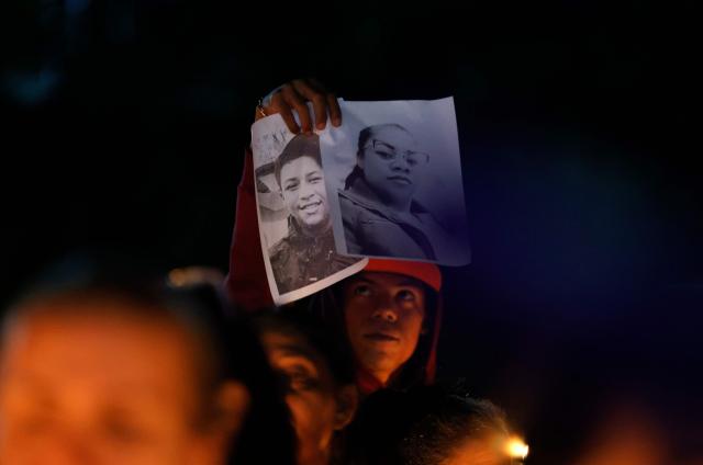 A man holds pictures of political prisoners during a candle vigil outside El Rodeo I prison in Guatire, Miranda State, some 30 kilometers east of Caracas on January 12, 2026. Venezuela said January 12, it had freed dozens more political prisoners as rights groups questioned the numbers and family members clamored for speedier releases after the US military ouster of long-term autocrat Nicolas Maduro. (Photo by Pedro MATTEY / AFP)