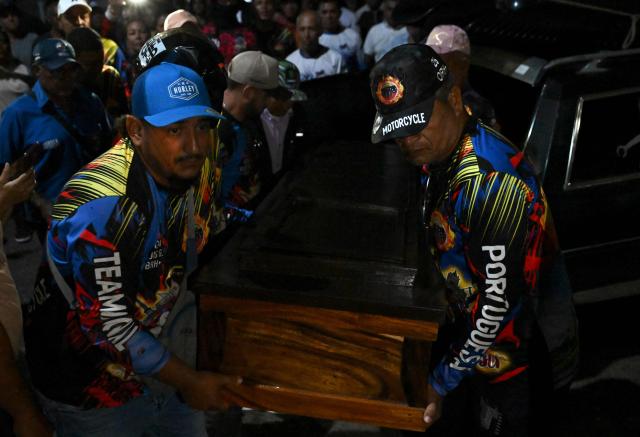 EDITORS NOTE: Graphic content / Relatives carry the coffin of political prisoner Edilson Torres who died in custody, during his funeral in Guanare, Portuguesa state, Venezuela on January 12, 2026. Venezuela said January 12, it had freed dozens more political prisoners as rights groups questioned the numbers and family members clamored for speedier releases after the US military ouster of long-term autocrat Nicolas Maduro. (Photo by Ronaldo SCHEMIDT / AFP)