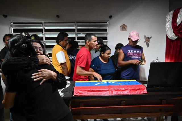 Relatives and friends of political prisoner Edilson Torres who died in custody, attend his funeral in Guanare, Portuguesa state, Venezuela on January 12, 2026. Venezuela said January 12, it had freed dozens more political prisoners as rights groups questioned the numbers and family members clamored for speedier releases after the US military ouster of long-term autocrat Nicolas Maduro. (Photo by Ronaldo SCHEMIDT / AFP)