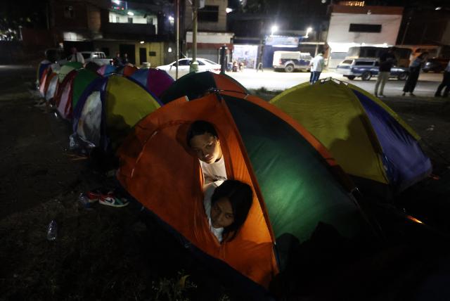 Women look out from a tent set up by relatives of political prisoners outside El Rodeo I prison in Guatire, Miranda State, some 30 kilometers east of Caracas on January 12, 2026. Venezuela said January 12, it had freed dozens more political prisoners as rights groups questioned the numbers and family members clamored for speedier releases after the US military ouster of long-term autocrat Nicolas Maduro. (Photo by Pedro MATTEY / AFP)
