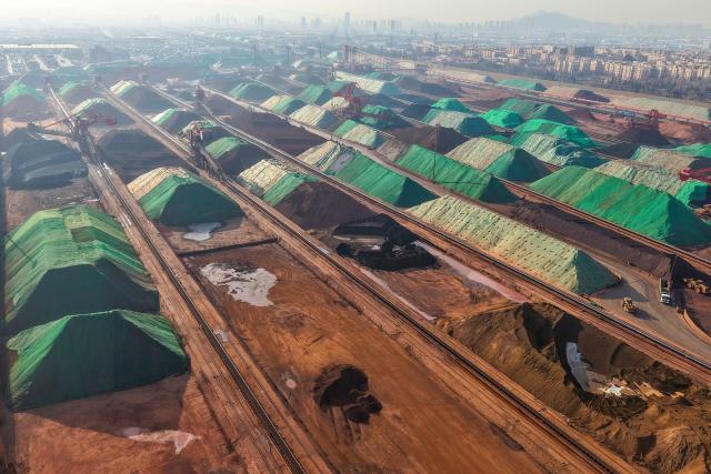 This aerial photo shows a general view of an iron ore terminal in Qingdao port, in China’s eastern Shandong province on January 12, 2026. (Photo by AFP) / China OUT