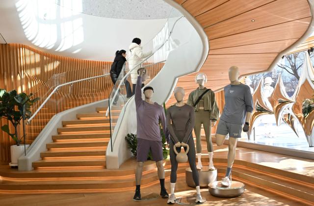 People visit a Lululemon store, a Canadian brand, in Beijing on January 13, 2026. (Photo by Adek BERRY / AFP)