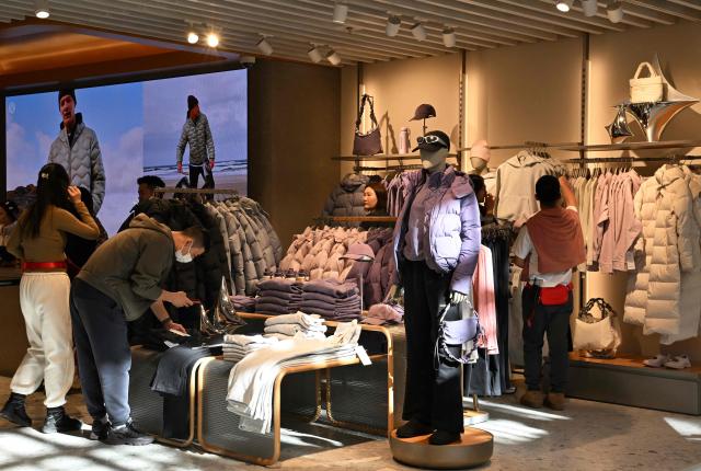 People visit a Lululemon store, a Canadian brand, in Beijing on January 13, 2026. (Photo by Adek BERRY / AFP)