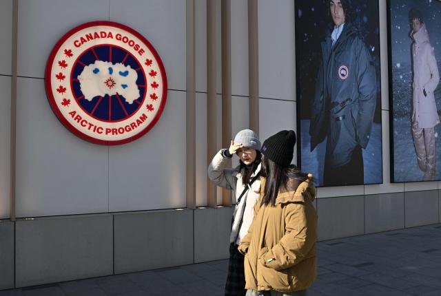 People walk past a Canada Goose store, a Canadian brand, in Beijing on January 13, 2026. (Photo by Adek BERRY / AFP)