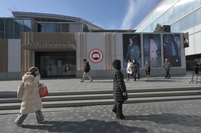 People walk past a Canada Goose store, a Canadian brand, in Beijing on January 13, 2026. (Photo by Adek BERRY / AFP)