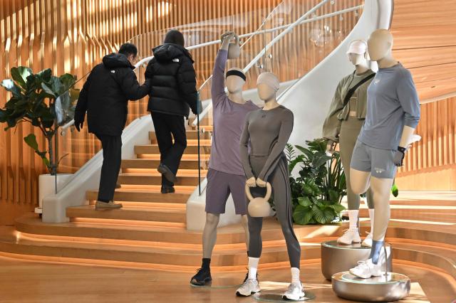 People visit a Lululemon store, a Canadian brand, in Beijing on January 13, 2026. (Photo by Adek BERRY / AFP)