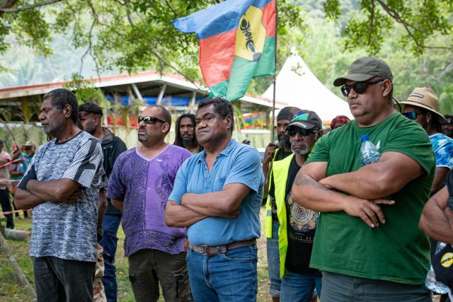 (FILES) Kanak pro-independence leader Christian Tein (C in a blue poloe shirt) takes part in a customary ceremony during the Kanak and Socialist National Liberation Front (FLNKS) during the congress of the Kanak and Socialist National Liberation Front (FLNKS), New Caledonia's main pro-independence movement, in Ponerihouen, in the French overseas collectivity of New Caledonia, on December 6, 2025. Caledonian independence movement, the Kanak and Socialist National Liberation Front (FLNKS), announced on January 13, 2026, that it would not attend the meeting on the institutional future of the archipelago organised by the French president at the Elysee Palace on January 16, 2026. (Photo by Delphine MAYEUR / AFP)