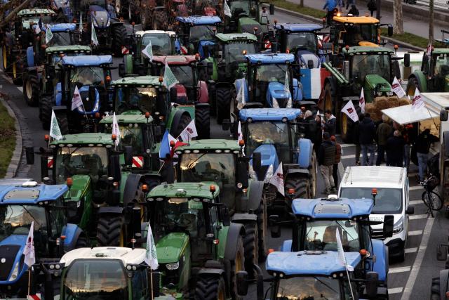 Tractors are parked along the Seine river as farmers protest to demand "concrete and immediate action" from the government, which is struggling to deal with the anger of farmers in Paris on January 13, 2026. Called by the FNSEA and "Jeunes Agriculteurs" unions and a few days before the signing of the EU-Mercosur agreement, a convoy of farmers entered the capital early in the morning. (Photo by GEOFFROY VAN DER HASSELT / AFP)