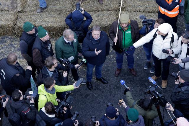 Representatives of French union National Federation of Agricultural Holders' Unions (FNSEA) talk to journalists as farmers protest to demand "concrete and immediate action" from the government, which is struggling to deal with the anger of farmers in Paris on January 13, 2026. Called by the FNSEA and "Jeunes Agriculteurs" unions and a few days before the signing of the EU-Mercosur agreement, a convoy of farmers entered the capital early in the morning. (Photo by GEOFFROY VAN DER HASSELT / AFP)