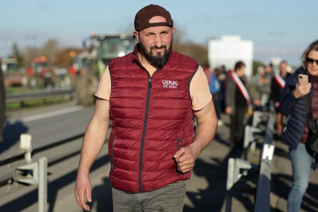 (FILES) French agricultural activist Jerome Bayle walks as farmers block the A64 motorway, during a demonstration in Carbonne, south-western France, on December 12, 2025. Law enforcement were present on the A64 motorway near Toulouse in the morning of January 13, 2026, with the aim of dismantling a roadblock that farmers have been maintaining there for a month. (Photo by Valentine CHAPUIS / AFP)