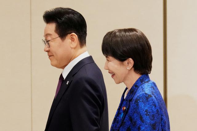 Japan's Prime Minister Sanae Takaichi (R) and South Korea's President Lee Jae Myung walk as they leave their joint news conference following their talk in Nara, western Japan on January 13, 2026. (Photo by Eugene Hoshiko / POOL / AFP)
