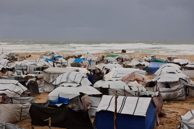 A photograph shows tent shelters housing displaced Palestinian families set up along the shore in Gaza City as strong winter winds sweep the Palestinian enclave on January 13, 2026. A fragile ceasefire has been in place since October, following a deadly war waged by Israel in response to Hamas's unprecedented October 7, 2023 attack on Israel. Nearly 80 percent of buildings in Gaza have been destroyed or damaged by the war, according to UN data. (Photo by Omar AL-QATTAA / AFP)