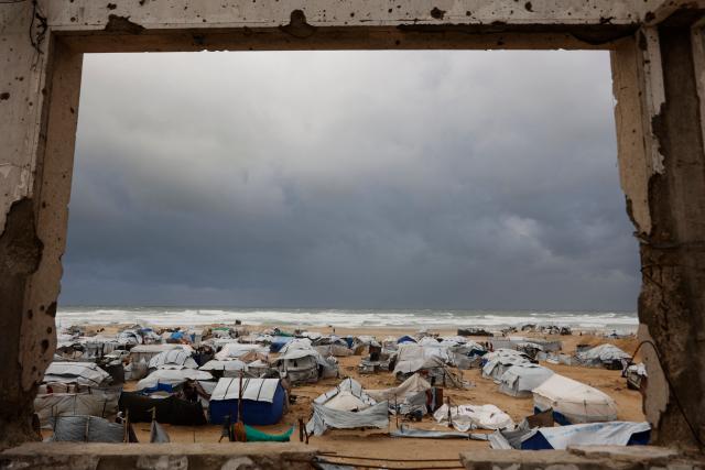 A photograph shows tent shelters housing displaced Palestinian families set up along the shore in Gaza City as strong winter winds sweep the Palestinian enclave on January 13, 2026. A fragile ceasefire has been in place since October, following a deadly war waged by Israel in response to Hamas's unprecedented October 7, 2023 attack on Israel. Nearly 80 percent of buildings in Gaza have been destroyed or damaged by the war, according to UN data. (Photo by Omar AL-QATTAA / AFP)