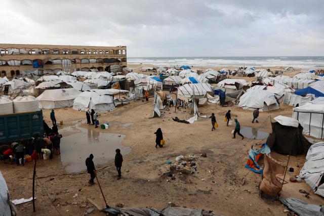 A photograph shows tent shelters housing displaced Palestinian families set up along the shore in Gaza City as strong winter winds sweep the Palestinian enclave on January 13, 2026. A fragile ceasefire has been in place since October, following a deadly war waged by Israel in response to Hamas's unprecedented October 7, 2023 attack on Israel. Nearly 80 percent of buildings in Gaza have been destroyed or damaged by the war, according to UN data. (Photo by Omar AL-QATTAA / AFP)
