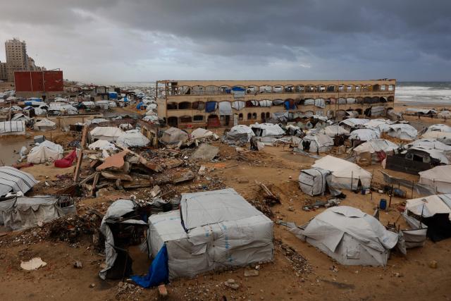 A photograph shows tent shelters housing displaced Palestinian families set up along the shore in Gaza City as strong winter winds sweep the Palestinian enclave on January 13, 2026. A fragile ceasefire has been in place since October, following a deadly war waged by Israel in response to Hamas's unprecedented October 7, 2023 attack on Israel. Nearly 80 percent of buildings in Gaza have been destroyed or damaged by the war, according to UN data. (Photo by Omar AL-QATTAA / AFP)