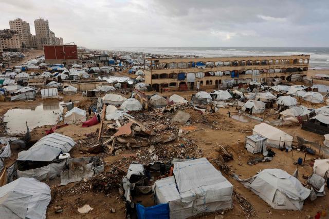 A photograph shows tent shelters housing displaced Palestinian families set up along the shore in Gaza City as strong winter winds sweep the Palestinian enclave on January 13, 2026. A fragile ceasefire has been in place since October, following a deadly war waged by Israel in response to Hamas's unprecedented October 7, 2023 attack on Israel. Nearly 80 percent of buildings in Gaza have been destroyed or damaged by the war, according to UN data. (Photo by Omar AL-QATTAA / AFP)