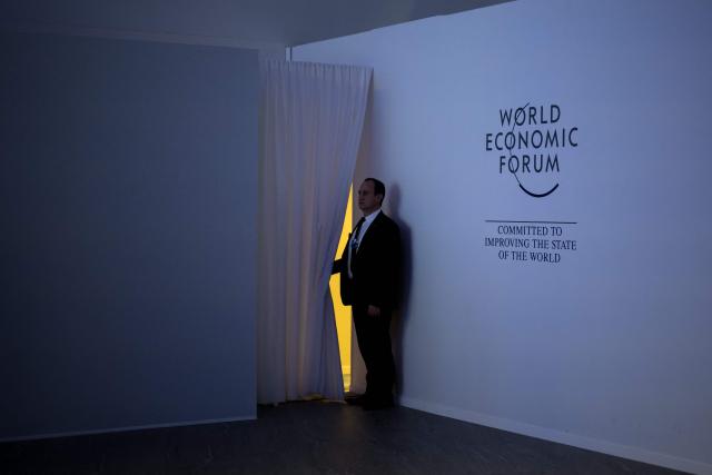 (FILES) A security staff member stands in the Congress hall during a session of the World Economic Forum (WEF) annual meeting in Davos on January 18, 2024. The World Economic Forum is taking place in Davos from January 19 to January 23, 2026. (Photo by Fabrice COFFRINI / AFP)