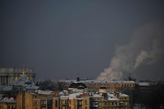 This photograph taken on January 13, 2026 shows buildings in central Kyiv, among them the Ukrainian Ministry of Foreign Affairs and St. Michael's Golden-Domed Monastery (R), with steam rising from chimneys in the background, amid the Russian invasion of Ukraine. (Photo by Sergei GAPON / AFP)