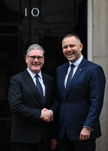 Britain's Prime Minister Keir Starmer greets Poland's President Karol Nawrocki outside of 10 Downing Street in central London on January 13, 2026. (Photo by JUSTIN TALLIS / AFP)