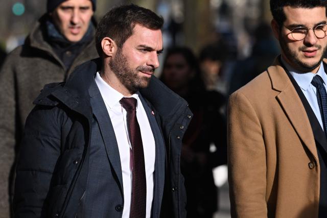MP for the French far-right party Rassemblement National (RN) Julien Odul (L) arrives for the appeal trial of RN's members on suspicion of embezzlement of European public funds, at Paris courthouse, on January 13, 2026. The appeal comes after a court last year barred the President of the RN parliamentary group Marine Le Pen from running for office for five years over a European Parliament fake-jobs scam involving her and other officials from her National Rally party. The hearing is expected to run until February 11, 2026, with a decision expected this summer.  Twelve of the accused, as well as the far-right party itself, have appealed against the verdict while another 12 people -- including one of Le Pen's sisters -- have decided to accept their convictions without appealing. (Photo by Martin LELIEVRE / AFP)