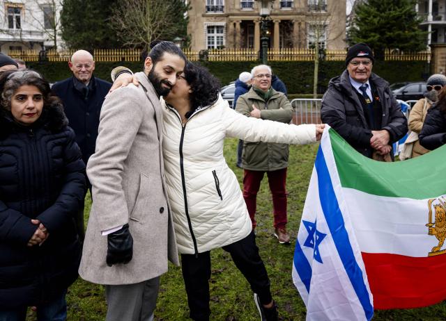 Dutch Member of Parliament Ulysse Ellian (VVD) and Iranian national Atti Bahadori react during a demonstration outside the Iranian Embassy in The Hague, on January 13, 2026. A violent crackdown on a wave of protests in Iran has killed at least 648 people, Norway-based NGO Iran Human Rights (IHR) said on January  12, as Iranian authorities sought to regain control of the streets with mass nationwide rallies. The demonstrations moved from protesting economic grievances to demanding a wholesale change from the clerical system that has ruled Iran since the 1979 revolution that ousted the shah. (Photo by Sem van der Wal / ANP / AFP) / Netherlands OUT