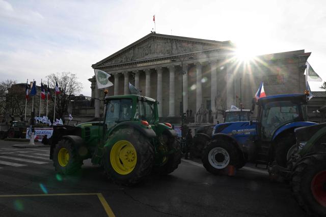 This photograph shows tractors parked in front of the National Assembly to demand "concrete and immediate action" from the government, which is struggling to deal with the anger of farmers in Paris on January 13, 2026. Called by the French union National Federation of Agricultural Holders' Unions (FNSEA) and "Jeunes Agriculteurs" union and a few days before the signing of the EU-Mercosur agreement, a convoy of farmers entered the capital early in the morning. (Photo by Martin LELIEVRE / AFP)