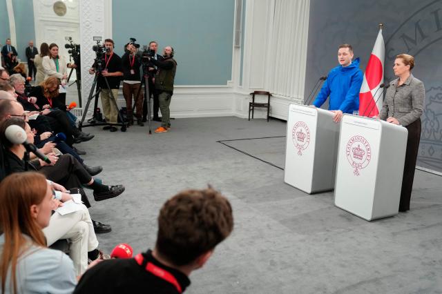 Greenland's Head of Government (Naalakkersuisut) Jens-Frederik Nielsen (L) and Denmark's Prime Minister Mette Frederiksen give a statement in the Mirror Hall at the Prime Minister's Office in Copenhagen, Denmark, on January 13, 2026. Nielsen said that the autonomous territory of Greenland would choose to remain Danish rather than become part of the United States, following US President Donald Trump's threats to take over the Arctic island. Frederiksen meanwhile said it had not been easy to stand up to what she slammed as "completely unacceptable pressure from our closest ally". (Photo by Liselotte Sabroe / Ritzau Scanpix / AFP) / Denmark OUT