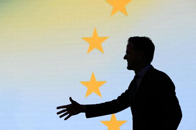 NATO Secretary General Mark Rutte gestures has he arrives on stage to deliver a keynote address to the Renew Europe Global Europe Forum 2026, called "Freedom on the Offensive: Fighting for a safe Europe", at the European Parliament, in Brussels, on January 13, 2026. (Photo by NICOLAS TUCAT / AFP)