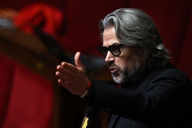 La France Insoumise - Nouveau Front Populaire's MP Aymeric Caron speaks during a session of questions to the government at the National Assembly, France's lower house parliament, in Paris, on January 13, 2026. (Photo by Anne-Christine POUJOULAT / AFP)